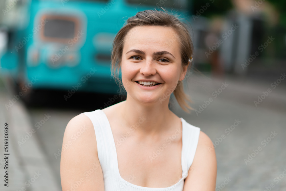 Close-up portrait of a happy woman in the city