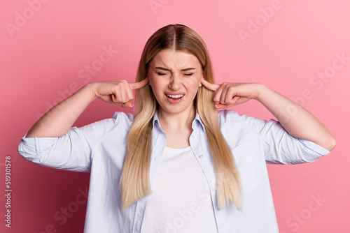 Photo of young girl close ears fingers loud noise irritated problem conflict isolated over pink color background
