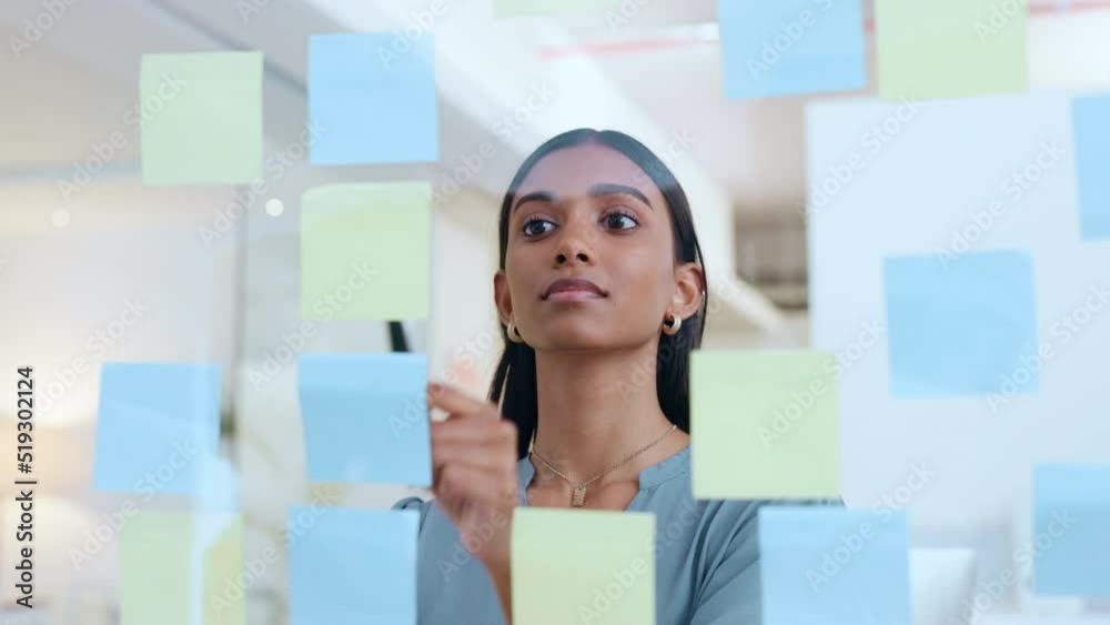 Young woman scheduling work strategy. Business female brainstorming, planning work showing corporate leadership, management skills. Lady taking detail information on tasks for company objectives.