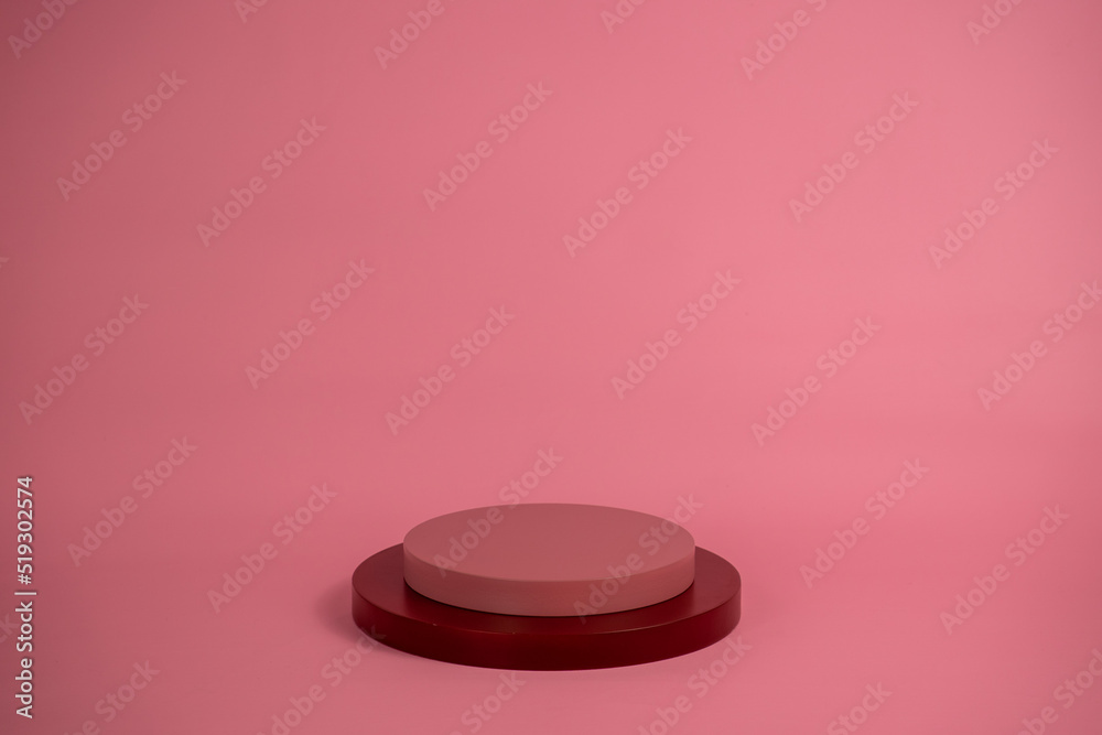 Empty podium for display cosmetic product. Platform arrangement in pink pastel color in trendy minimalist style. Composition of cylinders and cubes layout for feminine background