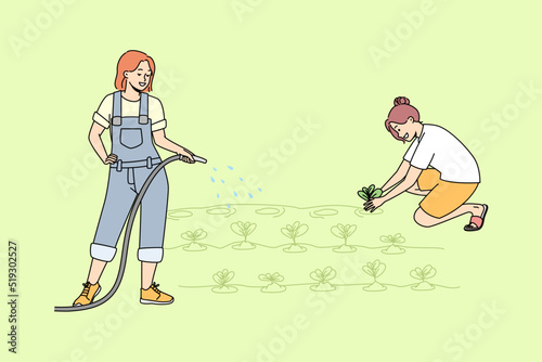 Young women working in garden watering plants together. Female cartoon characters involved in farming or agriculture at plantation. Vector illustration. 