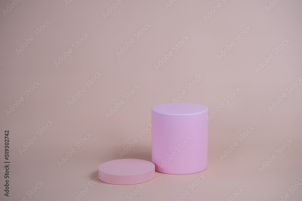Empty podium for display cosmetic product. Platform arrangement in pink pastel color in trendy minimalist style. Composition of cylinders and cubes layout for feminine background Empty podium for display cosmetic product. Platform arrangement in pink pastel color in trendy minimalist style. Composition of cylinders and cubes layout for feminine background