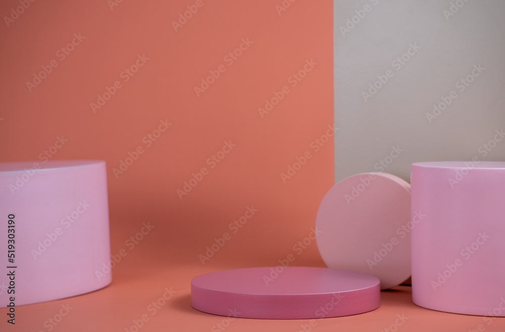 Empty podium for display cosmetic product. Platform arrangement in pink pastel color in trendy minimalist style. Composition of cylinders and cubes layout for feminine background Empty podium for display cosmetic product. Platform arrangement in pink pastel color in trendy minimalist style. Composition of cylinders and cubes layout for feminine background