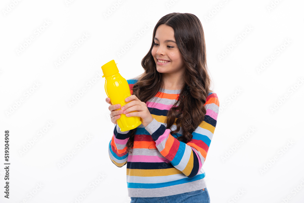Teenage girl hold water bottle isolated on yellow background. Water bottle and healthy life. Health and water balance. Drink and beverage concept. Happy girl face, positive and smiling emotions. Teenage girl hold water bottle isolated on yellow background. Water bottle and healthy life. Health and water balance. Drink and beverage concept. Happy girl face, positive and smiling emotions.