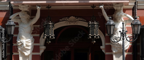 Decoration of the facade of the building with sculptures and busts of Atlantes photo