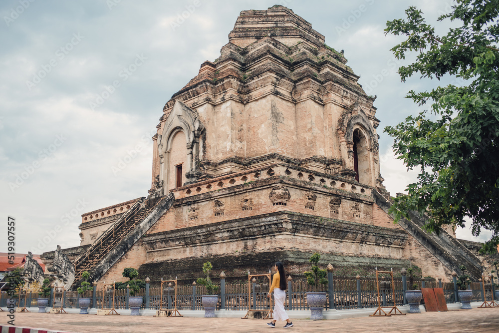 ํYoung Asia woman walking in Wat Chedi Luang temple that is highly revered in Chiang Mai. ํYoung Asia woman walking in Wat Chedi Luang temple that is highly revered in Chiang Mai.