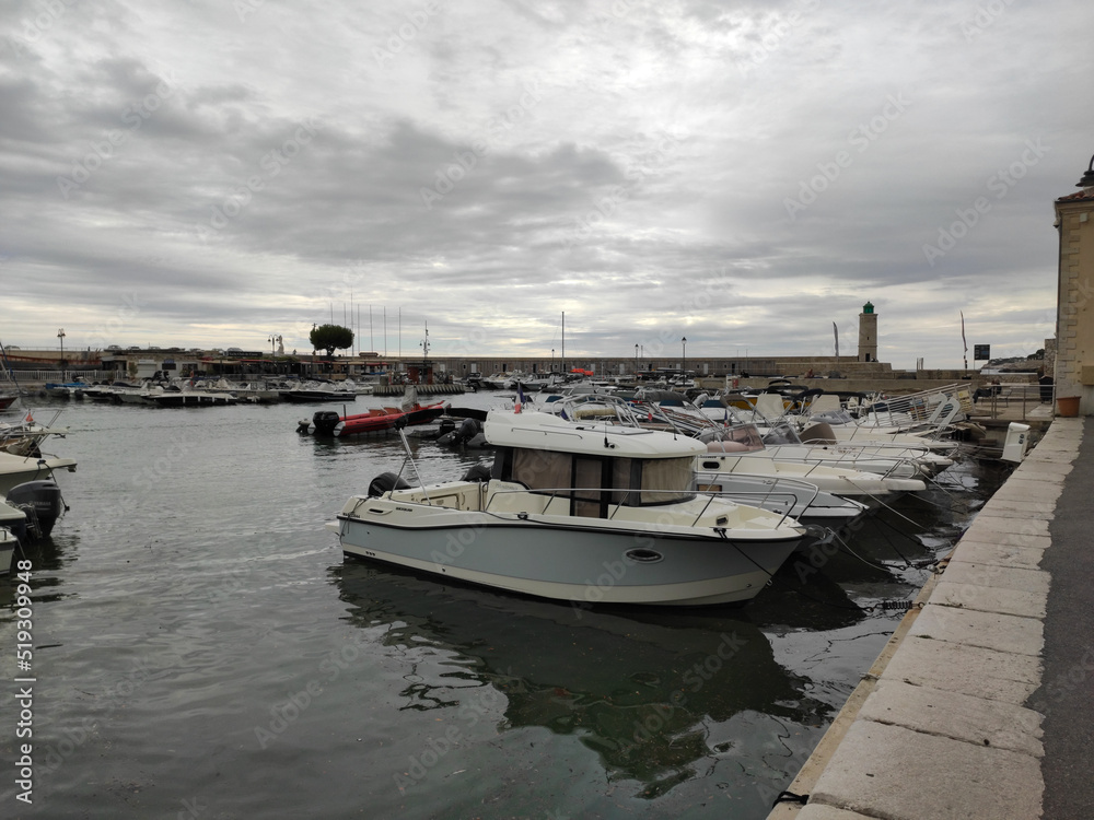 Fototapeta premium Cassis, France, October 5, 2021: The Marina of Cassis. Cassis marina is also a fishing and trading port. Traditional houses, restaurant terraces and boats docked at the port of Cassis.