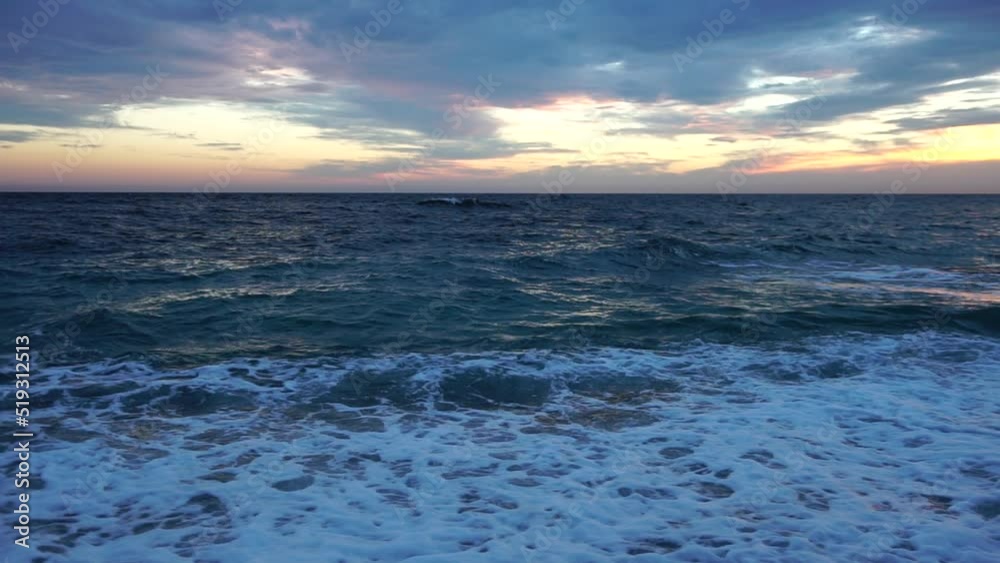 Dramatic Seascape over the beach during sunset, with rocky volcanic cliff is lit by the warm sunset. Evening sky with clouds. Nobody. The concept of calmness silence and unity with nature. Dramatic Seascape over the beach during sunset, with rocky volcanic cliff is lit by the warm sunset. Evening sky with clouds. Nobody. The concept of calmness silence and unity with nature.