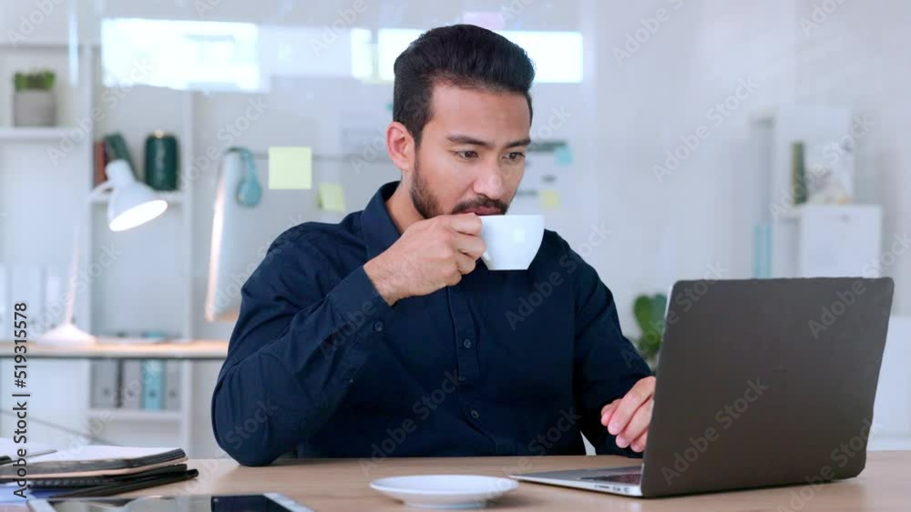 Happy young male office manager working on his computer at his job. A confident business man drinking his coffee at a desk. Smiling employee reading his email online at work. Happy young male office manager working on his computer at his job. A confident business man drinking his coffee at a desk. Smiling employee reading his email online at work.