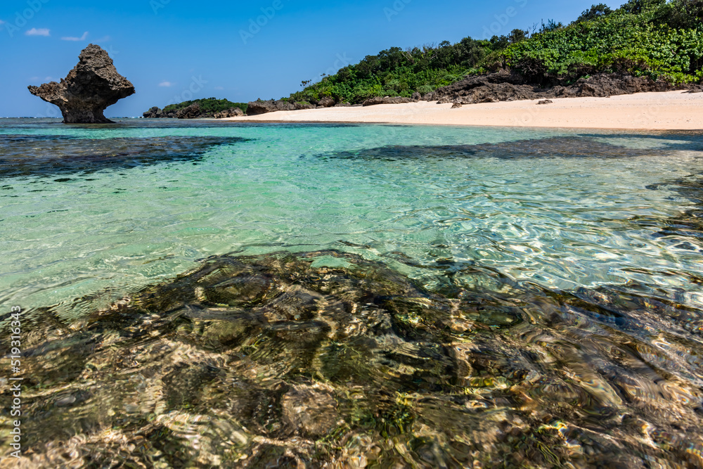 Impressive crystal clear sea waters with glistening surface, sunny day at a paradise beach.