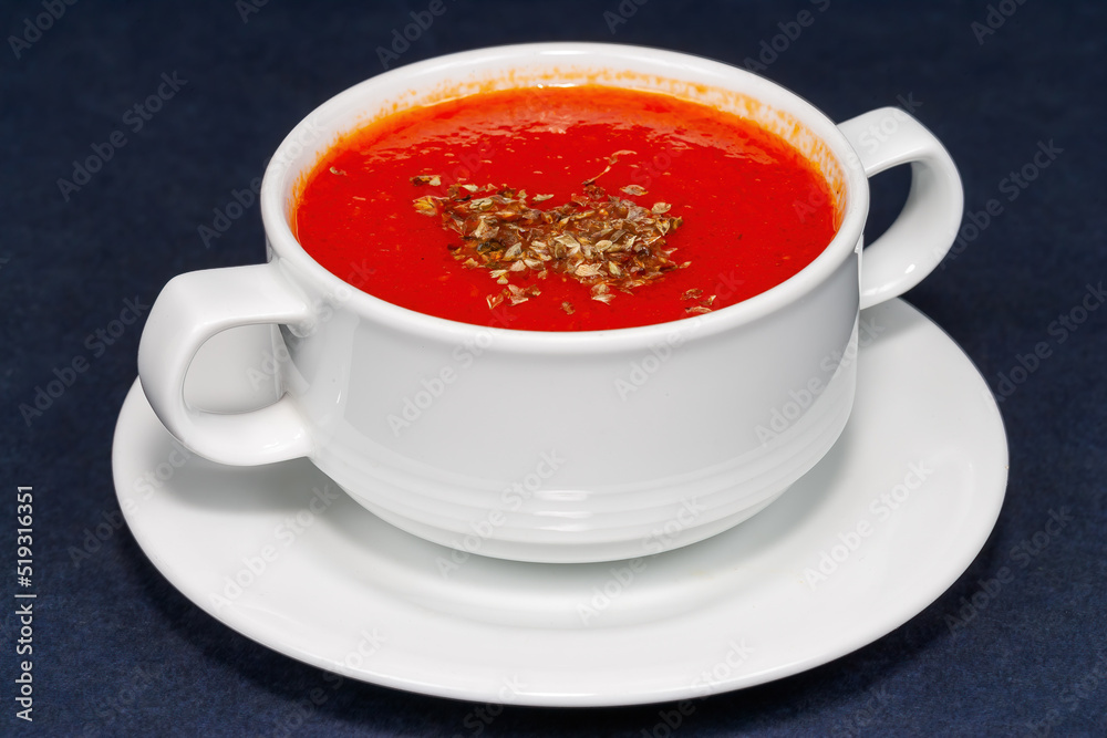 Traditional tomato cream soup in a white bowl Traditional tomato cream soup in a white bowl