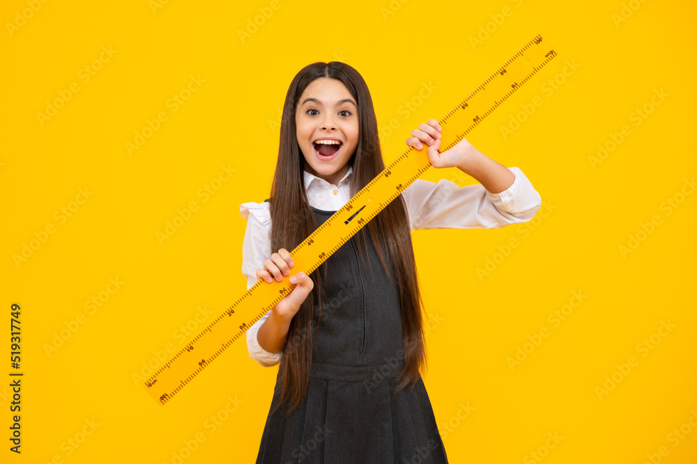 School girl holding measure for geometry lesson, isolated on yellow background. Measuring equipment. Student study math. Excited face, cheerful emotions of teenager girl. School girl holding measure for geometry lesson, isolated on yellow background. Measuring equipment. Student study math. Excited face, cheerful emotions of teenager girl.