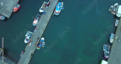 4k aerial video of Vilafranca do Campo's Pier (Dock). Anchored and fixed boats' drone video. photo