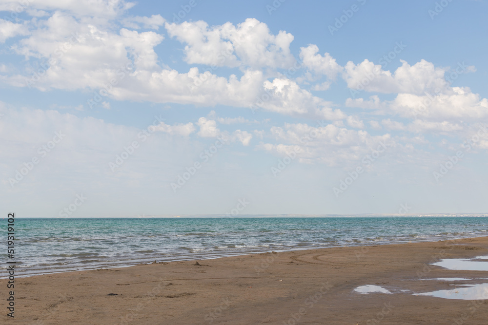 Sandy beach with blue sea and blue sky and white cloud is beautiful on the coast. beautiful blue ocean shore outdoor nature landscape water background.