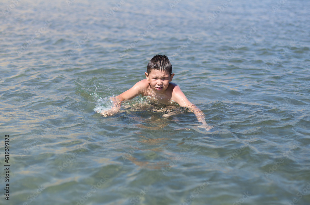 boy bathes in warm sea water