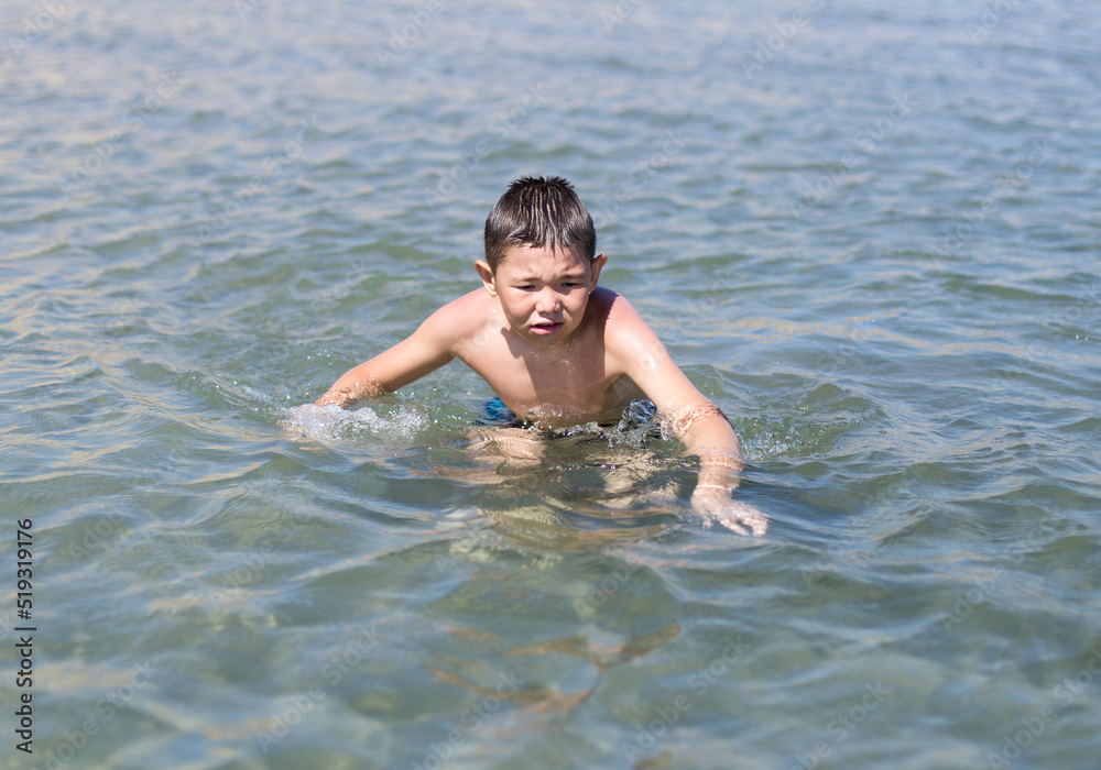 boy bathes in warm sea water