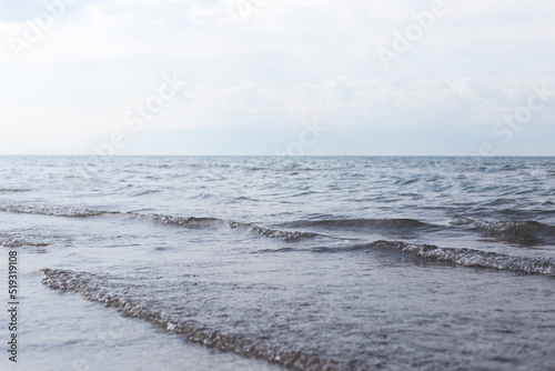 Fototapeta Naklejka Na Ścianę i Meble -  Sandy beach with blue sea and blue sky and white cloud is beautiful on the coast. beautiful blue ocean shore outdoor nature landscape water background.