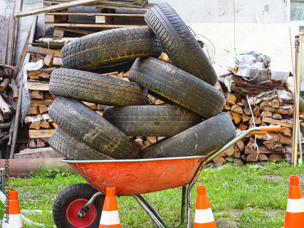 Fototapeta premium pile of car tires ready for recycling stacked in a trolley