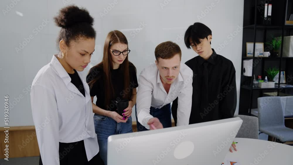 The boss tells his team about the new project by showing it on the computer monitor The boss tells his team about the new project by showing it on the computer monitor