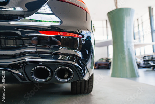 the exhaust pipe of the new black car. 