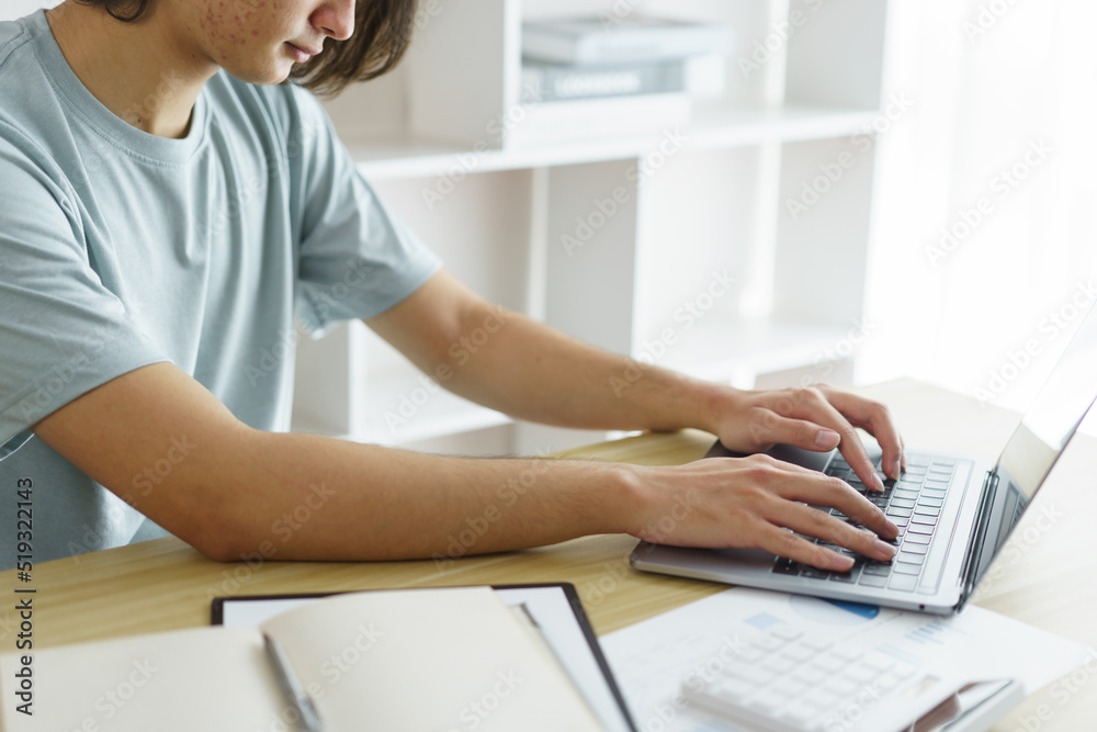 Distance education concept, Teen boy wear headphone to lesson class online and type chat in skype Distance education concept, Teen boy wear headphone to lesson class online and type chat in skype