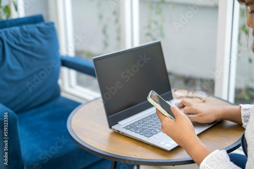 Woman business lifestyle working laptop office modern. shopping online for payment in notebook. female writer keyboarding happy cheerful pleased. girl freelance working at a coffee shop. out of focus © Tamonwan