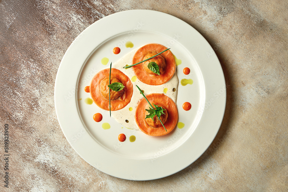 Orange ravioli filled with sauce. Close-up, selective focus Orange ravioli filled with sauce. Close-up, selective focus