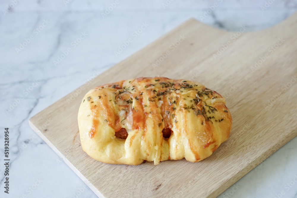 Sausage buns bread. Soft baked bun (dough) stuffed with sausage for fast food breakfast or coffee break. Sausage roll, (hot dog).
With mayo, tomato sauce, mozarella cheese and parsley topping

