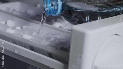 Pour water into the ice maker compartment. Make your own ice in the freezer compartment of the refrigerator. photo