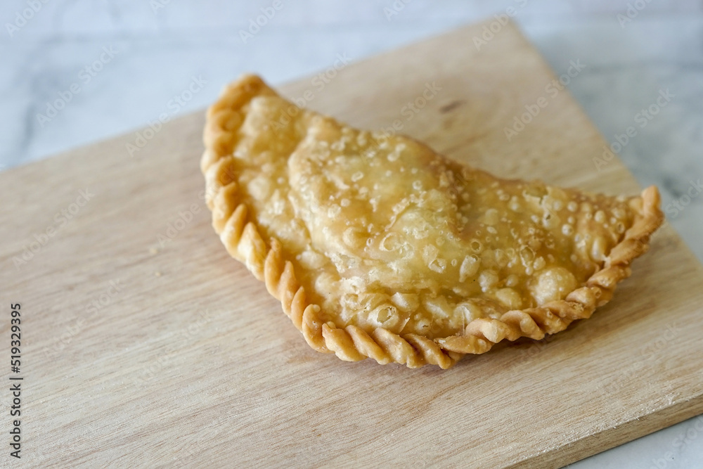 Cornish pasty filled with chicken and potato. Pastry minced pie or Pastel asian style cuisine. Homemade flaky pasty with mince meat filling - obrazy, fototapety, plakaty 