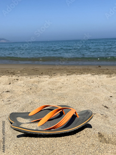 Pair of flip-flops on the beach