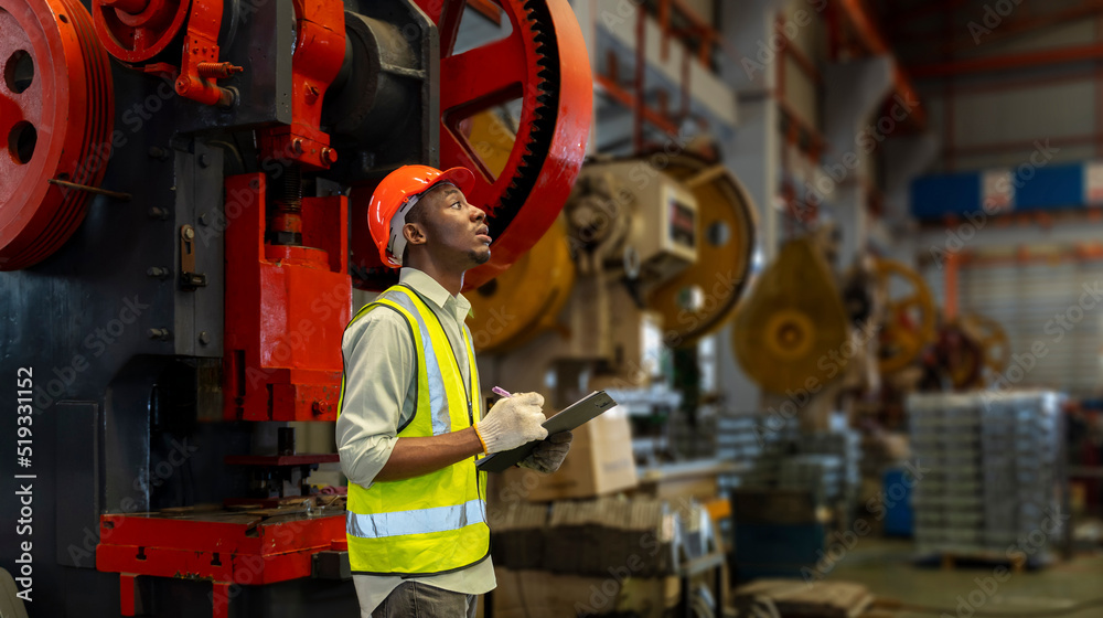 African American industrial worker is using clipboard to take note