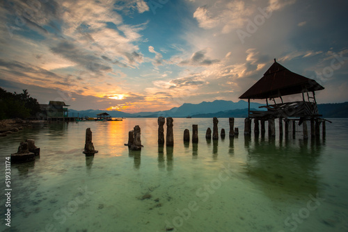 stunning sunset on the beach Tanjung Putus Lampung. building on a clear sea under a sunset. Indonesian landscapes tropical beaches