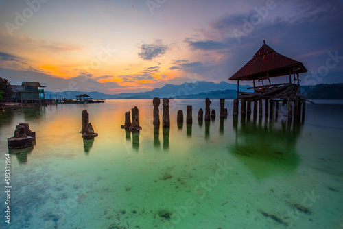 stunning sunset on the beach Tanjung Putus Lampung. building on a clear sea under a sunset. Indonesian landscapes tropical beaches