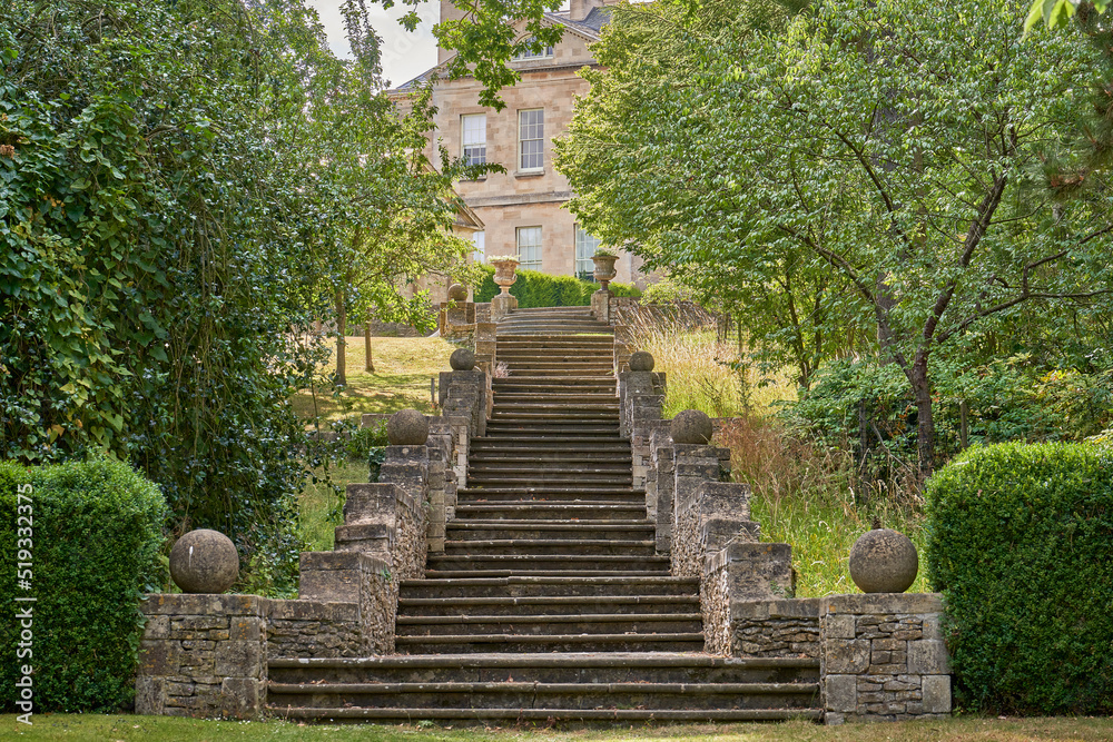 Stone garden steps leading up to a stately home