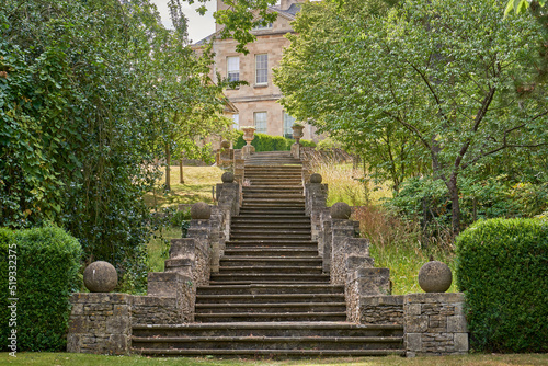 Stone garden steps leading up to a stately home