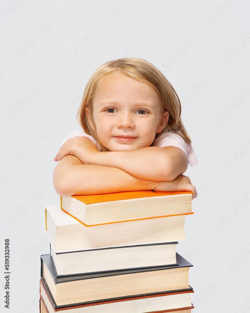 smiling beautiful cute little girl leaning on thick books smiling beautiful cute little girl leaning on thick books