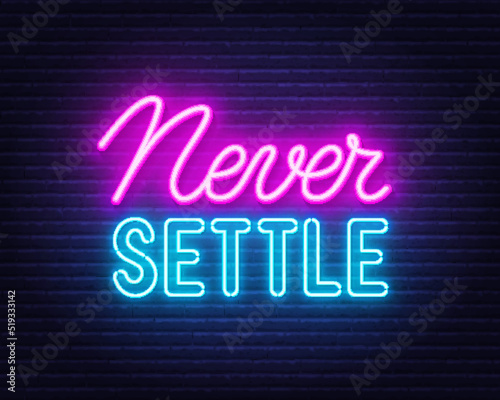 Never Settle l neon quote on a brick wall.