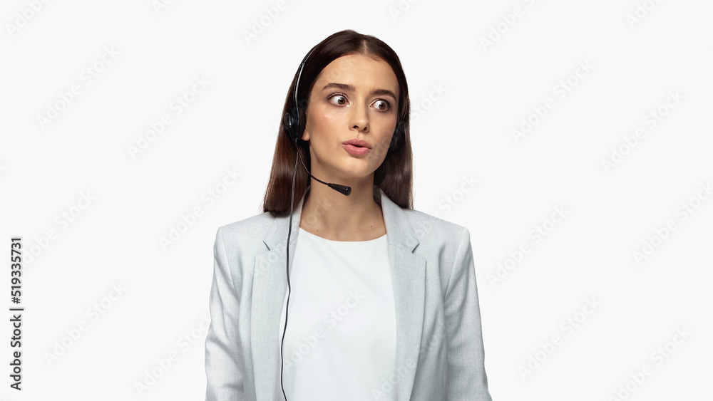 young operator in headset with microphone and grey blazer talking isolated on white.