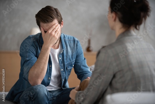 Psychologist talking with patient on therapy session.