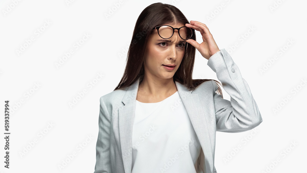 confused businesswoman in grey blazer adjusting eyeglasses isolated on white. confused businesswoman in grey blazer adjusting eyeglasses isolated on white.