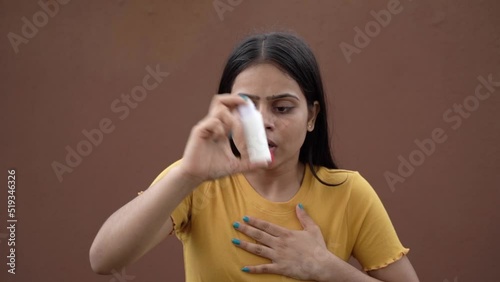 Asthmatic patient catching inhaler having an asthma attack. Slow motion young woman having asthma, chronic obstructive pulmonary disease photo