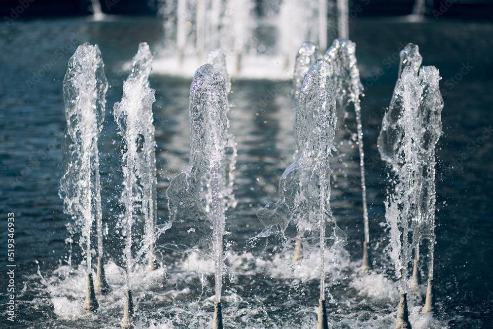 Close-up of a fountain in the park. Jets of water are Close-up of a fountain in the park. Jets of water are