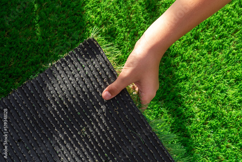 Close-up of the back of a roll of artificial turf. Synthetic artificial grass material easy to install and maintain