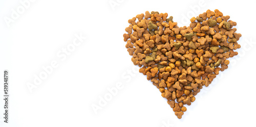 Valentines day and love of pets concept. Heart shaped cat dry kibble food on white background