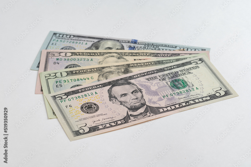 5, 20, 50, 100 dollars banknotes at different angles. Close up of dollars on white background. 5, 20, 50, 100 dollars banknotes at different angles. Close up of dollars on white background.