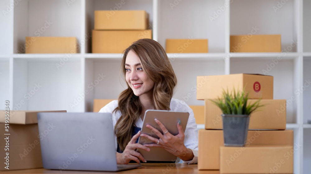 Portrait of Starting small businesses SME owners female entrepreneurs working on receipt box and check online orders to prepare to pack the boxes, sell to customers, sme business ideas online. Portrait of Starting small businesses SME owners female entrepreneurs working on receipt box and check online orders to prepare to pack the boxes, sell to customers, sme business ideas online.