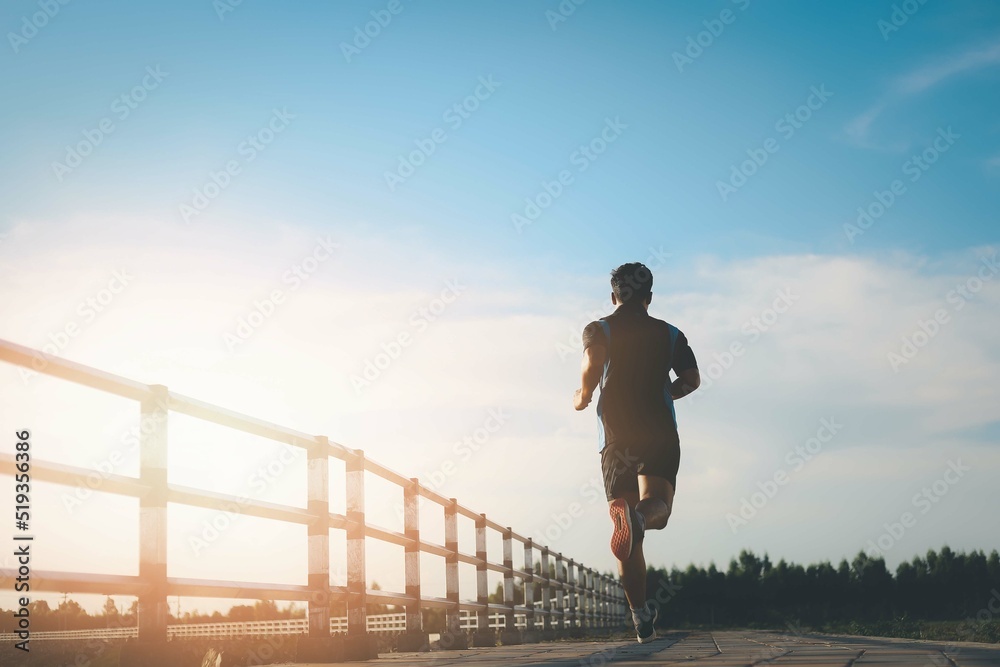 The man with runner on the street be running for exercise.,healthy lifestyle young fitness man running