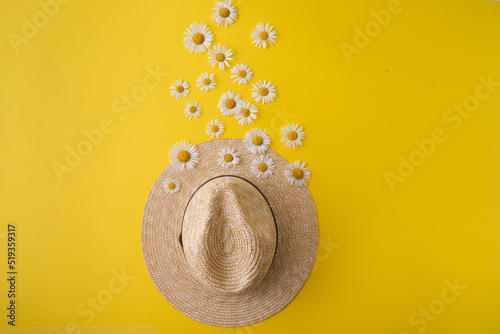 straw hat and daisies around