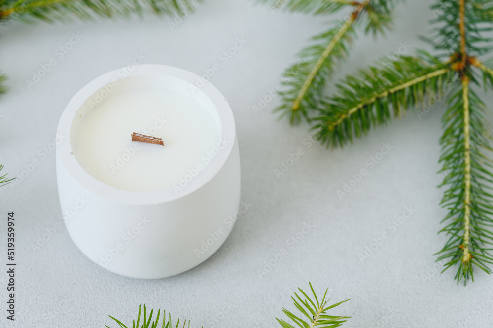 Green Christmas Tree Branches and Round White Candle Top View. Candlestick Planter close-up Green Christmas Tree Branches and Round White Candle Top View. Candlestick Planter close-up